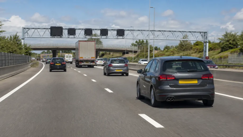 When Would You Use the Right-Hand Lane on a Three-Lane Motorway? Car safely using the right-hand lane to overtake slower traffic on a three-lane UK motorway.